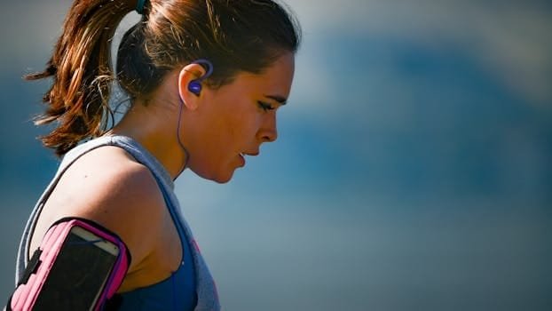 pexels-photo-2291874-2291874 Woman Wearing Smartphone Armband And Blue Earphones