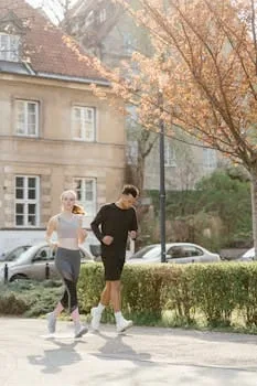 Young couple enjoys a jog outdoors in a sunlit park setting during spring.